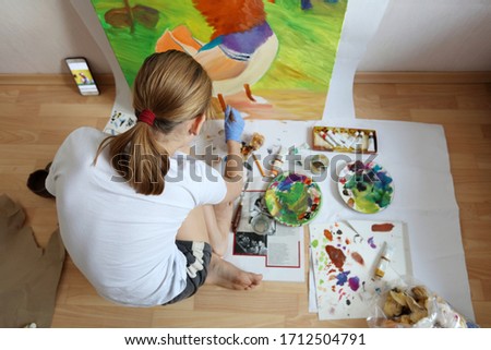 Female teenager painting during the lockdown at home