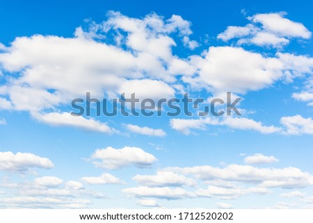 blue sky with many white cumuli clouds on sunny March day Royalty-Free Stock Photo #1712520202