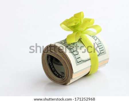 U.S. dollars banknotes with a green ribbon as a gift of money  Royalty-Free Stock Photo #171252968