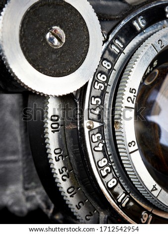 Aperture, shutter speed and focus ring on an old folding camera