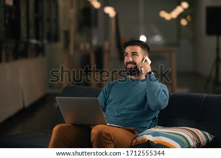 Young businessman talking to the phone in office. Handsome man have a phone call.
