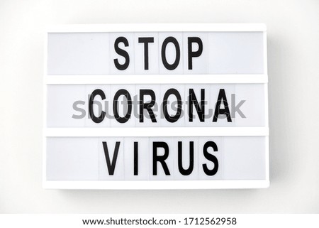 medicine, epidemic and healthcare concept - lightbox with stop coronavirus caution words on white background