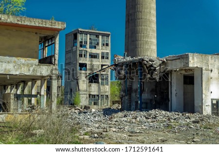 Remains of abandoned heavy industry plant built and used during communist era in former Yugoslavia. Royalty-Free Stock Photo #1712591641