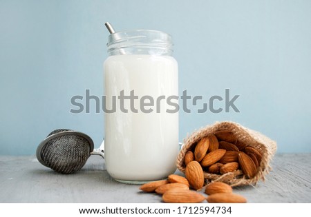 Vegetarian almond milk. Almonds and almond milk in a bottle. Organic healthy vegan product widely used in cosmetology and Spa