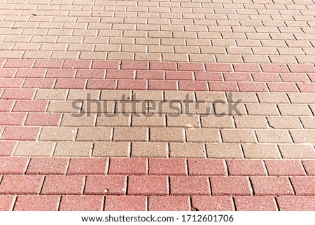 Top view on paving stone road. Old pavement of granite texture. Street cobblestone sidewalk. Abstract background for design.