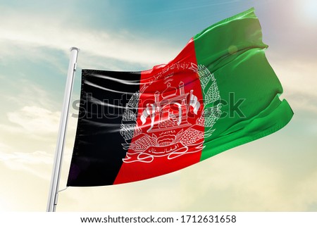 Afghanistan national flag cloth fabric waving on the sky with beautiful sky - Image