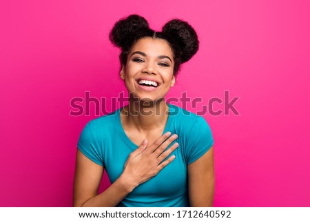 Closeup photo of beautiful cheerful lady two buns hairdo good mood laughing out loud arm on chest wear blue casual t-shirt isolated vivid pink color background