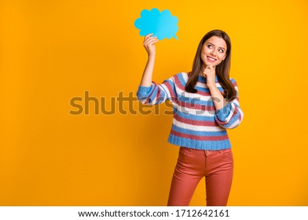 Portrait of interested minded girl hold blue paper card speech bubble think thoughts about future spring holiday free time wear jumper pants isolated over bright shine color background