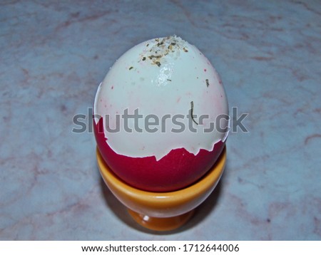 Peeled Easter egg topped with Adyghe salt. A natural and healthy product. Colorful Easter eggs - part of the passover meal.