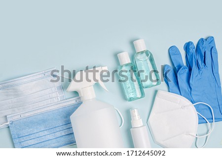 White medical masks and respirators with glove, hand sanitizer on blue background.  Face mask protection  KN95 or N95 and surgical masks for protection virus, flu, coronavirus, COVID-19.   Royalty-Free Stock Photo #1712645092