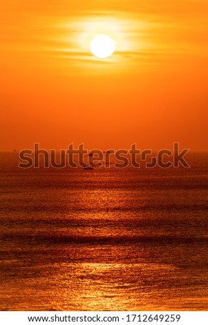 The setting sun over the Indian Ocean, the orange tinted sea and sky