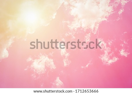 Sunny orange pink sky background. Beautiful warm sky with clouds