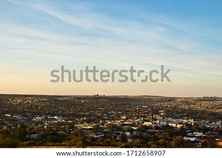 A landscape image of the town of Makhanda (Grahamstown), South Africa during sunset.