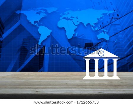 Bank flat icon on wooden table over world map, modern city tower and skyscraper, Business banking online concept, Elements of this image furnished by NASA