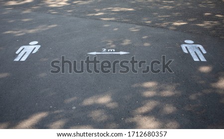 Social distancing two metre sign on pathway