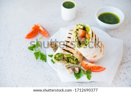 Burritos wraps with mushrooms and vegetables, a traditional Mexican food.