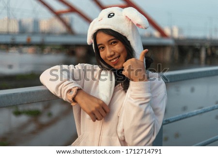 A Vietnamese girl standing on an old bridge