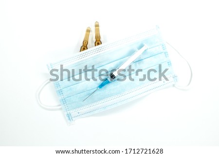 syringe with needle, two ampoules and corona virus mask Royalty-Free Stock Photo #1712721628