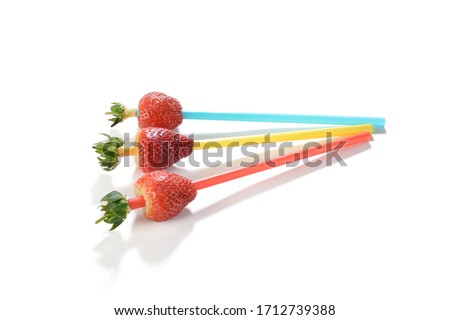 Life hack; Insert the straw into the side opposite to the stem and press it up through the center of the strawberry.    