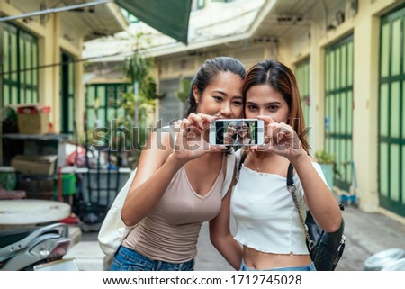Two attractive girls taking a selfie while exploring city stock photo