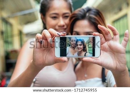 Close up selfie portrait of two young smiling woman stock photo