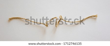 Small canvas rope on white background in the warm light.
