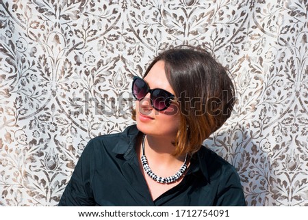 Portrait of beautiful woman in black and white necklace. Minimalist geometric fashion jewelry.