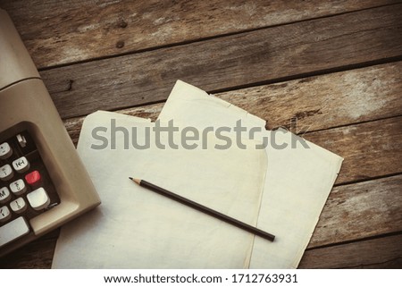 Typewriter, pensil and paper on wooden background. Literature, author and writer, creative writing workshop and journalism concept.