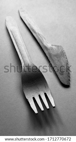 Contrast plastic and bamboo wooden fork and knife black and white. Eco-friendly disposable cutlery