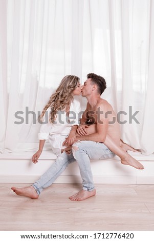happy young couple together in white room. Portrait of cheerful casual people in love, students having hopes, dreams, goals, bride and groom with family wants and aspirations