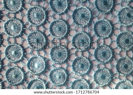 Light blue crochet lace fabric from above