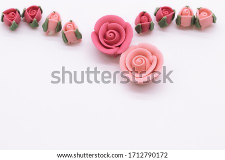 pink decorative sugar rose on a white background. wedding, mothers day, valentine card concept. copy space