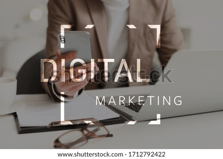 Businessman with mobile phone in office, closeup. Concept of digital marketing