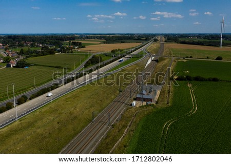 Aerial view of a railway, next to the E40 highway, in Crenwick, Belgium