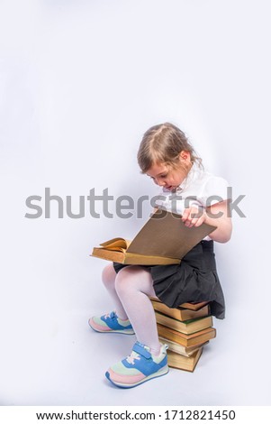 Back to school concept background. Education background. Little cute kid girl with books, magnifying glass and notebooks. Child girl reading a book. White gray background, banner mockup, copy space