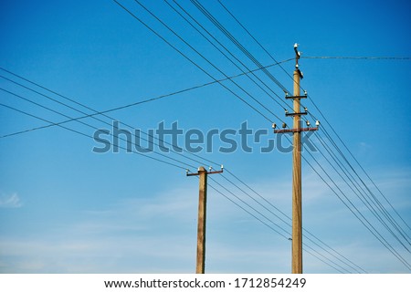 Closeup of old power poles on a clear summer day.	 Royalty-Free Stock Photo #1712854249