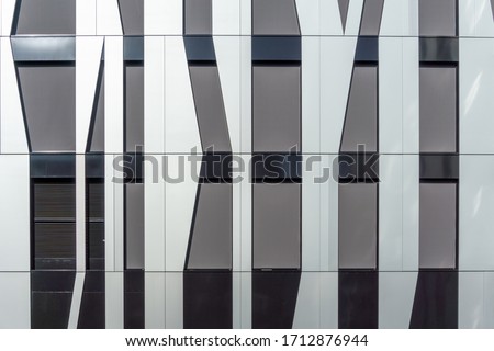 Detail of a modern office building with decorative, irregular shaped facade panels. Abstract Architecture. High resolution photography. 