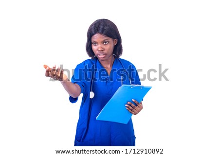 young charming nurse in lab coat standing on white background with stethoscope and folder making hand gesture