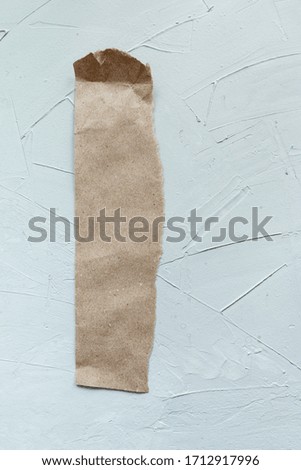 craft empty paper stick for message to remember, concrete wall background 