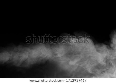 White water vapour on isolated black background. Abstract of steam with copy space. Steam flow. Smoke on black background. Royalty-Free Stock Photo #1712939467