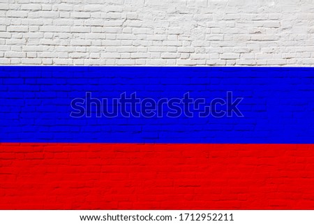 National flag of Russian federation painted on brick wall. Photo collage.