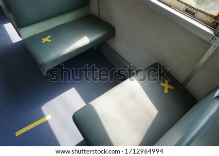 Safe travels new normal seats train put warning yellow signs  not allowed sitting for social distancing stop spreading covid-19 for public health. Concept social distancing, safe travels.