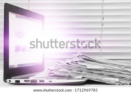 Newspapers and Laptop. Different Concepts for News -  Network or Traditional Tabloid Journals. Data Sources - Electronic Screen of Computer or Paper Pages of Magazines, Internet or Papers             