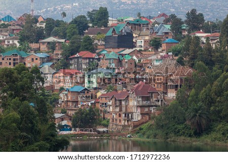 view of the bukavu city colorful roofs harbor over kivu lake Royalty-Free Stock Photo #1712972236