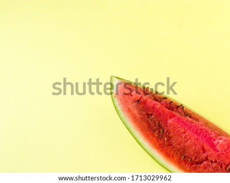 Watermelon stock photo with light yellow background.