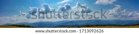 Panorama of the blue sky with light, backlit by the sun, clouds. Summer sky in the mountains Royalty-Free Stock Photo #1713092626