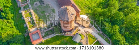 Panoramic aerial view photo from flying drone  over River Gauja valley, with Turaida Castle in the middle of it during sunny summer day, Sigulda, Latvia. (series)