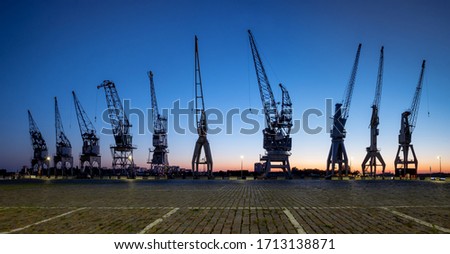 Old harbor cranes in the city of Antwerp. Royalty-Free Stock Photo #1713138871