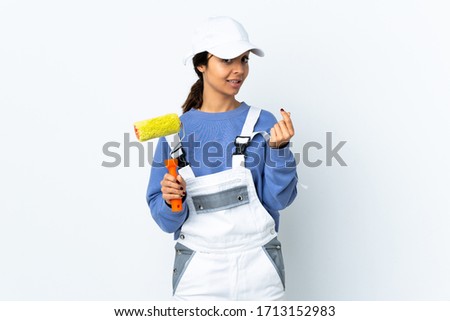 Painter woman over isolated white background making money gesture