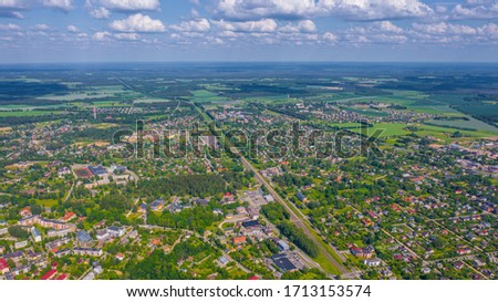 Beautiful panoramic aerial view photo from flying drone over Sigulda city on a sunny summer day against the background of forests and countryside. Sigulda, Latvia (series)
